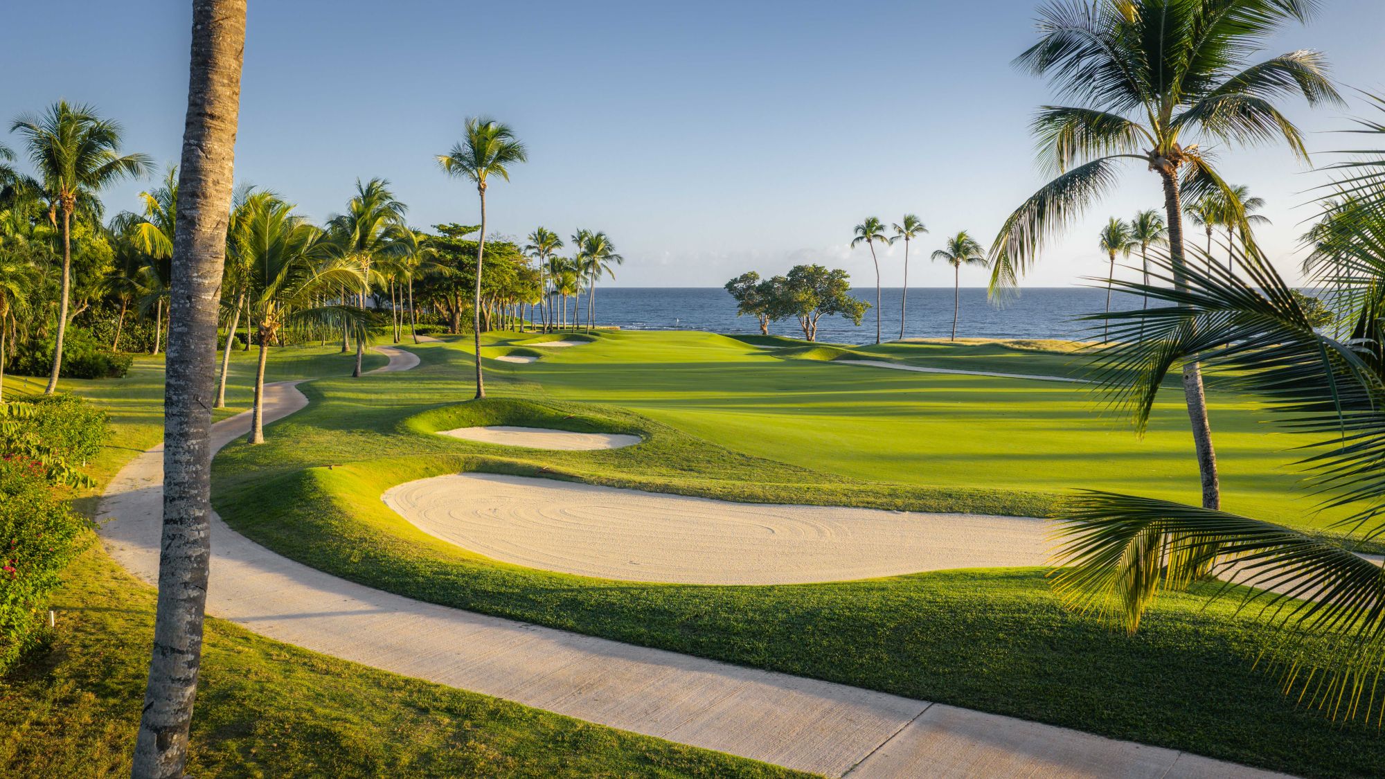 Calle de Teeth of the Dog al amanecer con el Caribe al fondo: reservar golf en Casa de Campo empieza por la primera tanda de salidas